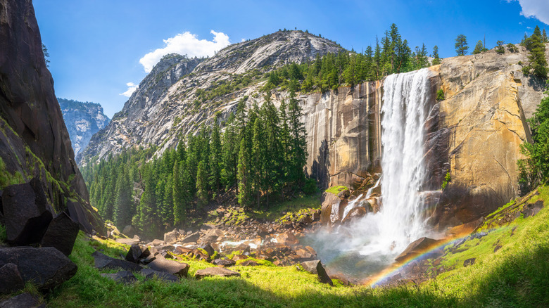 The Mist Trail leads to a huge waterfall cascading over granite cliffs at Yosemite National Park.