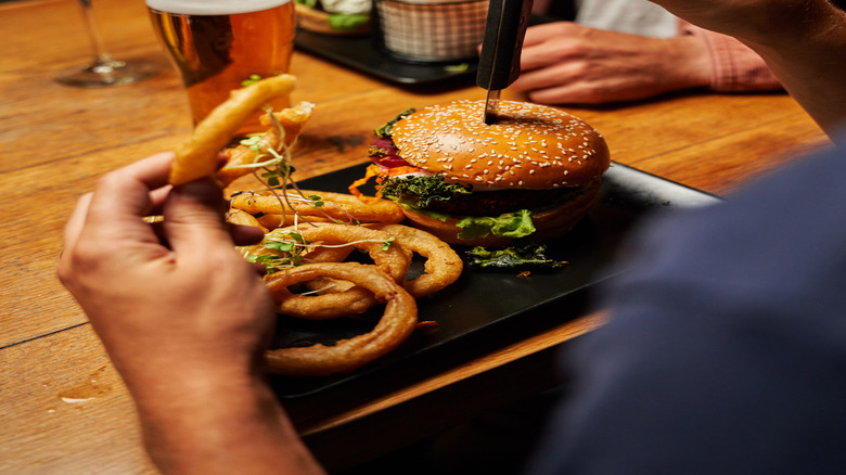 Friends sharing burgers and drinks