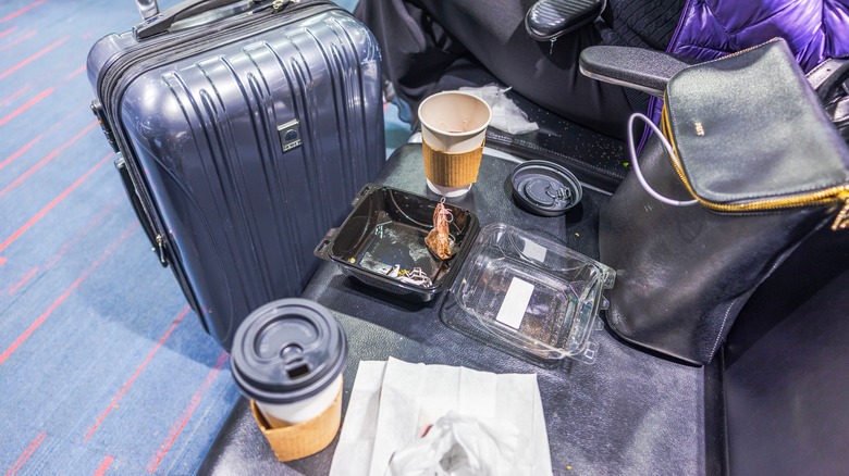 Suitcases and empty food and drink containers at JFK Airport