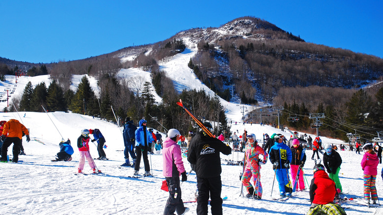 Hunter Mountain instructor surrounded by skiers in brightly colored clothes