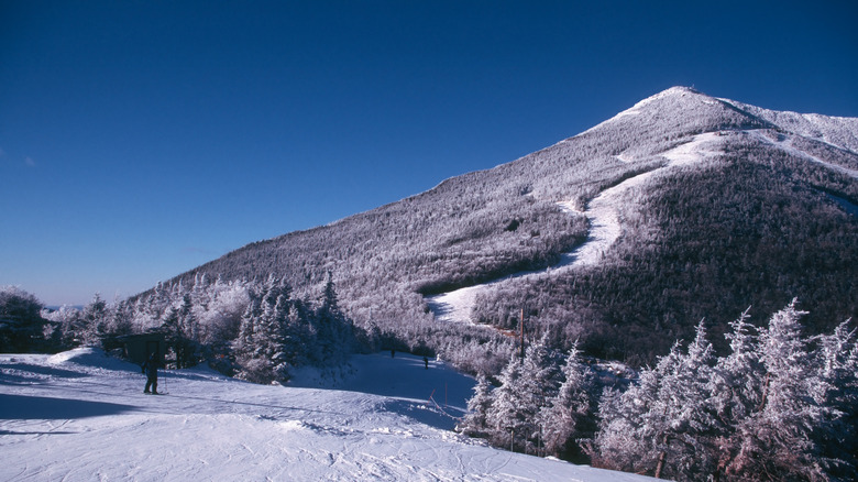 A person skiing at Whiteface next to a snow-covered mountain