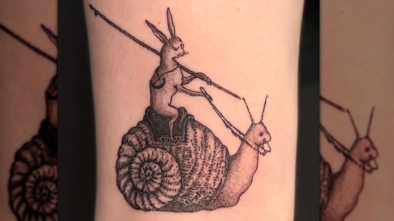 A tattoo of a rabbit riding a snail by artist Payne at Zen Ink, Asheville, NC