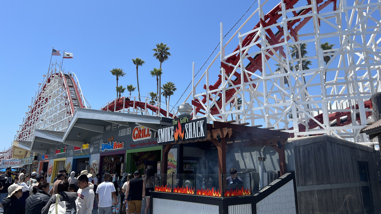Crowds stand beneath the Giant Dipper rollercoaster at the Santa Cruz Beach Boardwalk, in California.