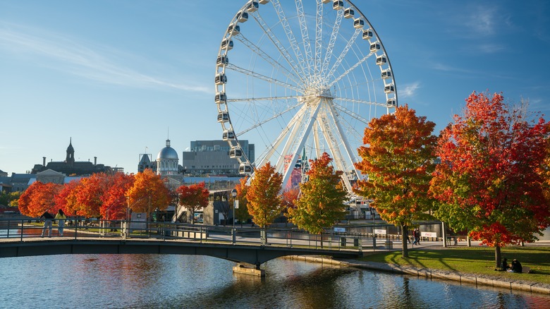 A Ferris wheel rises over the St. Lawrence River in Montreal, Canada