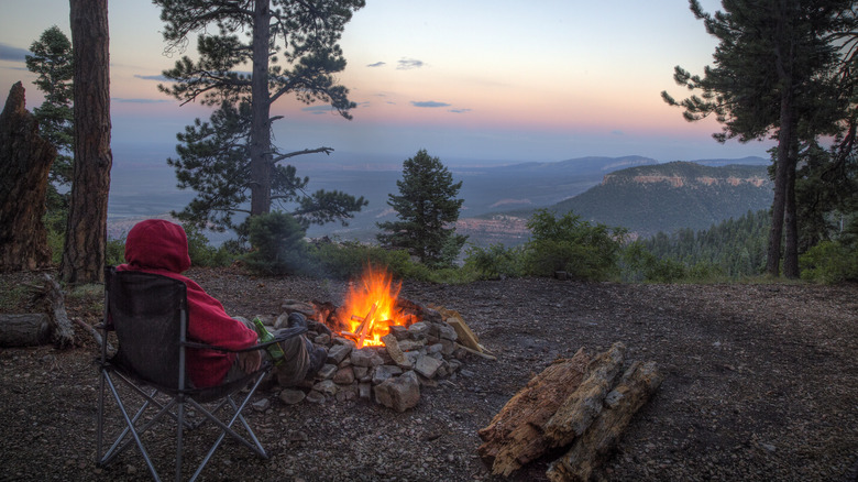 Camper sitting in front of a campfire in Grand Canyon National Park