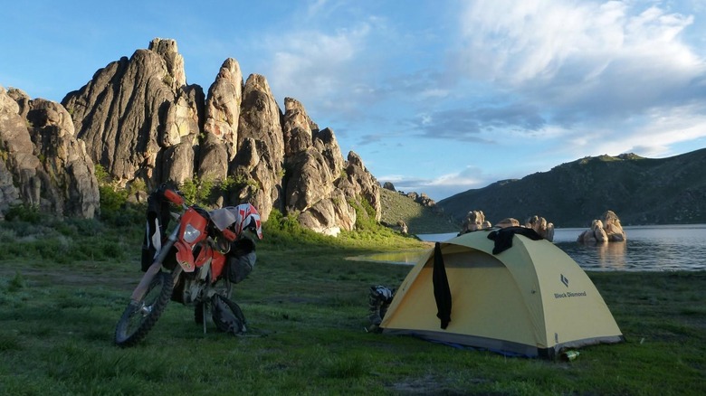 Motorcyle and tent next to Knott Creek Reservoir in Nevada