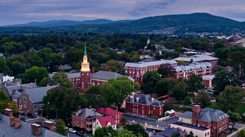 Aerial view of buildings and mountains at night in Charlottesville
