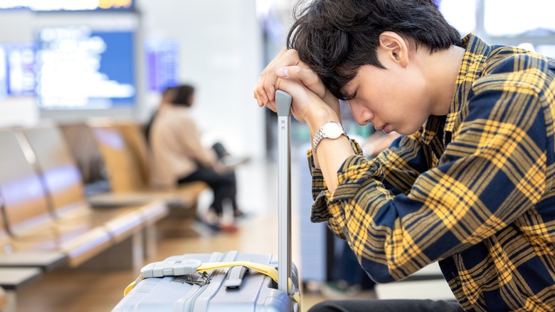Worried young man at an airport
