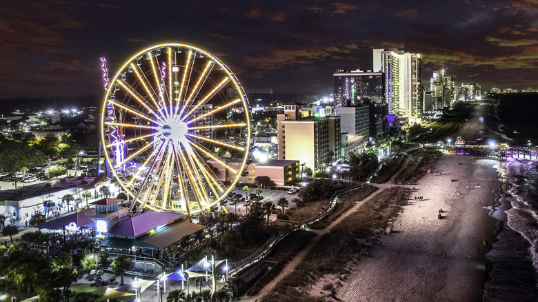 The Myrtle Beach beachfront and Ferris wheel lighting up at night