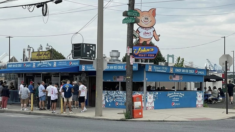 people lined up outside of John's Roast Pork in Philadelphia