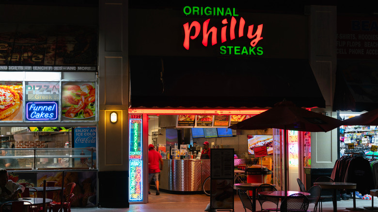 storefront of Philly cheesesteak shop at night