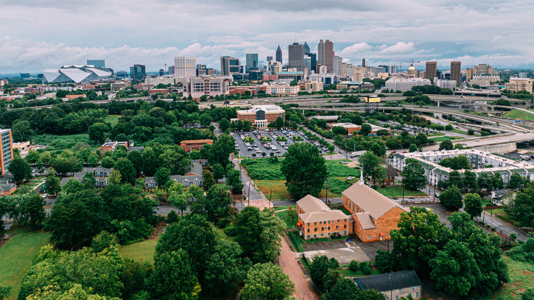 Aerial view of Downtown Atlanta with green treetops in the foreground