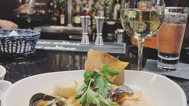 Seafood platter and glass of wine at bar of Caprice Bistro