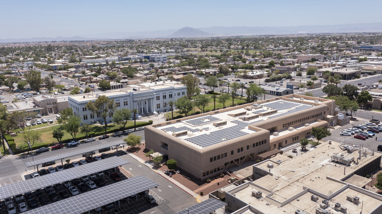 The urban downtown area of El Centro with low-lying buildings, cars, and trees.
