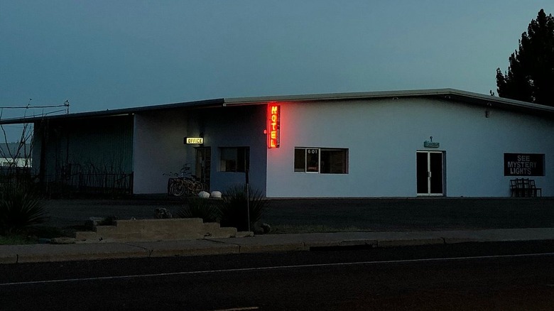 Red neon sign outside the Thunderbird Hotel building in Texas