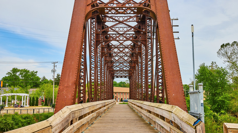 A trestle bridge rises above a wood-planked section of the Ohio to Erie Trail