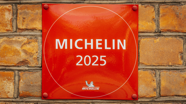 Red Michelin 2025 plaque hanging on brick wall
