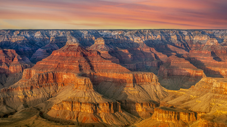 The red and orange rocks of the Grand Canyon illuminated in sunlight
