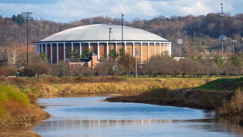 Rotunda building facing the river against trees background