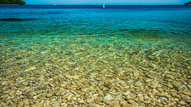 Smooth rocks seen through the clear water at Schoolhouse Beach on Washington Island in Wisconsin.