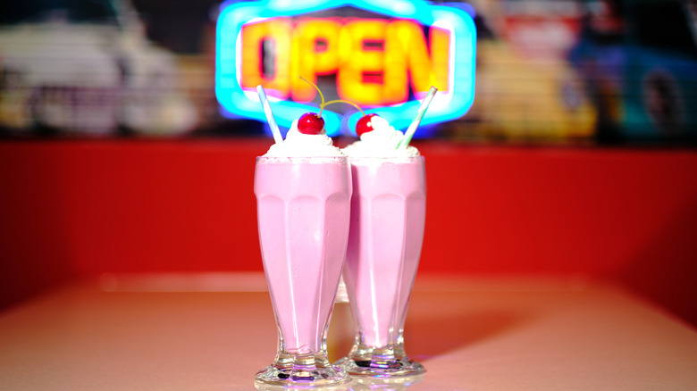 Neon sign and milkshake at retro diner