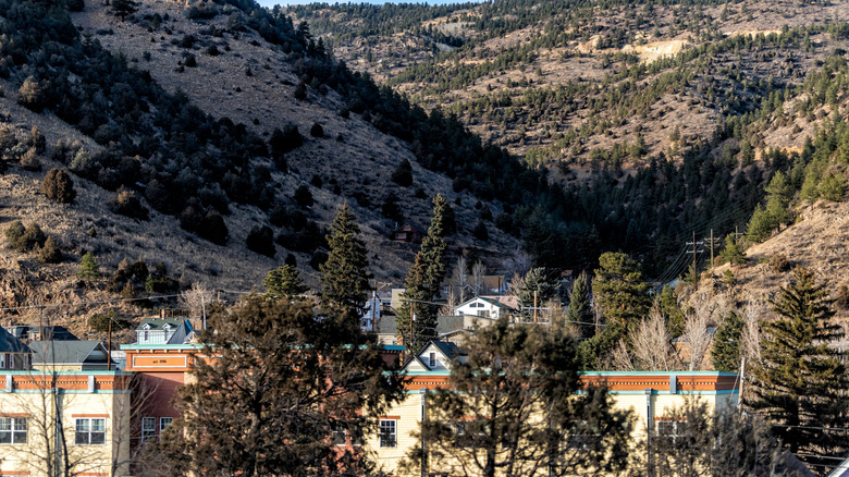 The town of Idaho Springs surrounded by wooded mountains