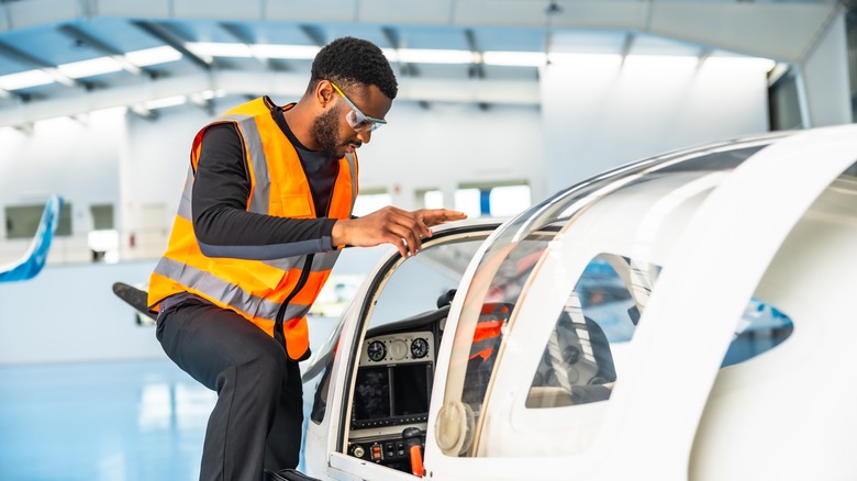 Aircraft maintenance engineer checking a plane's cockpit