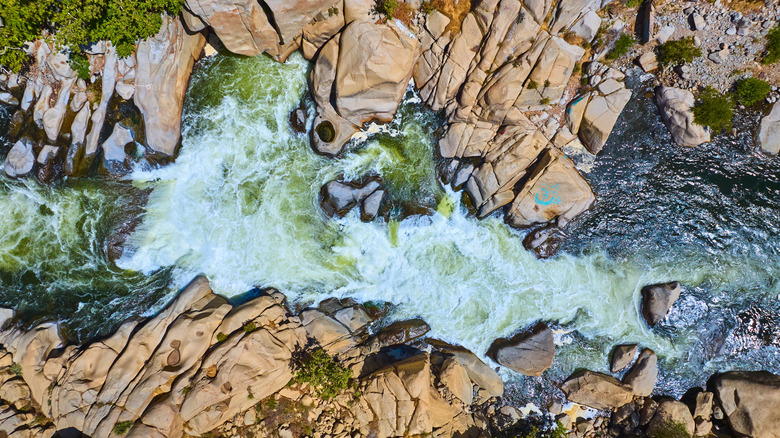 A rapid runs through a gorge on a river in California