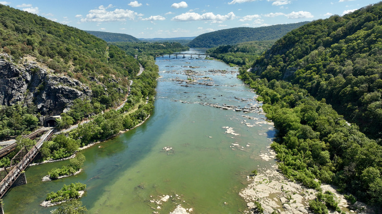 Green mountains rise on either side of the Potomac River