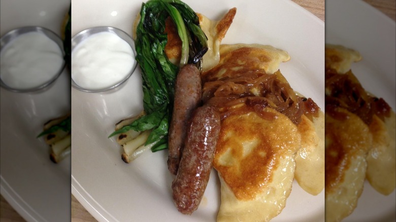 Pierogies, sausages, and greens adorn a plate at Butterjoint