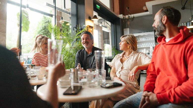 Group of friends chat in cafe