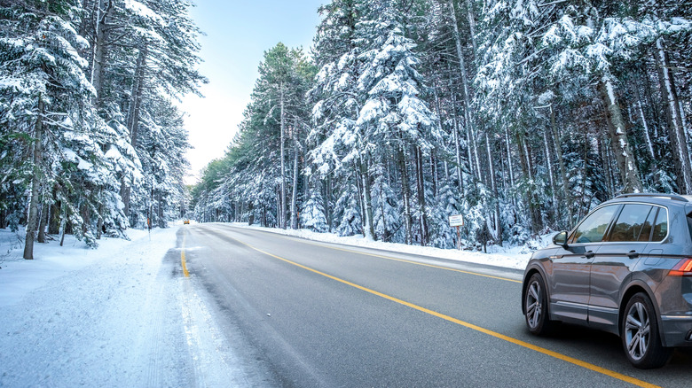 Car driving through a snow-covered scene