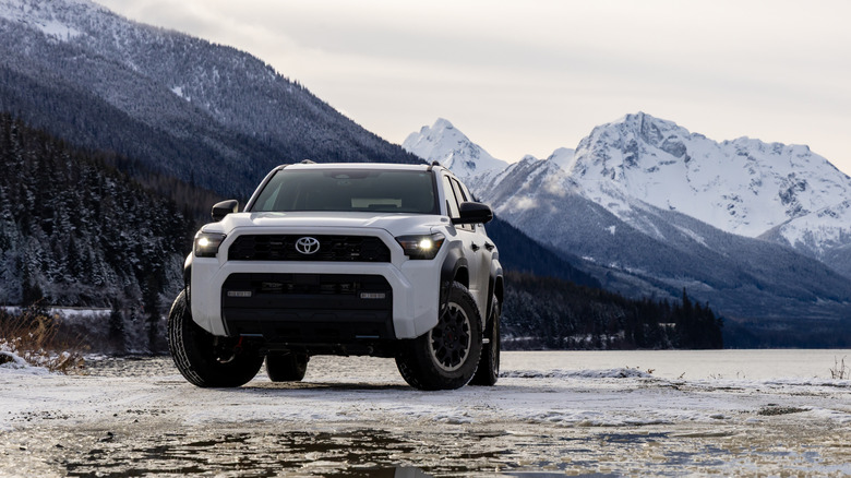 A white Toyota 4Runner parked next to a snowy lake
