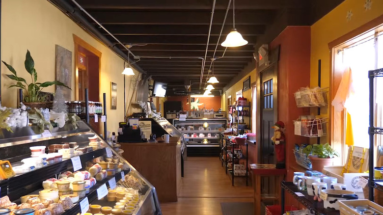 counters and shelves filled with cheese inside the narrow Edelweiss Cheese Shop