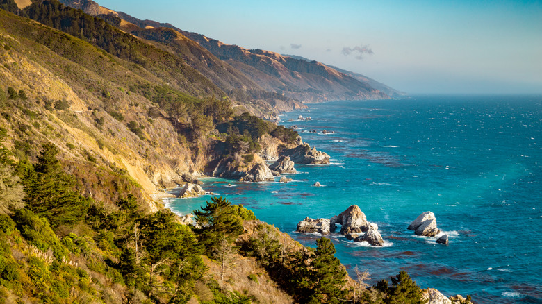 The rugged Big Sur coastline with aquamarine water and ridges topped with shrubs.