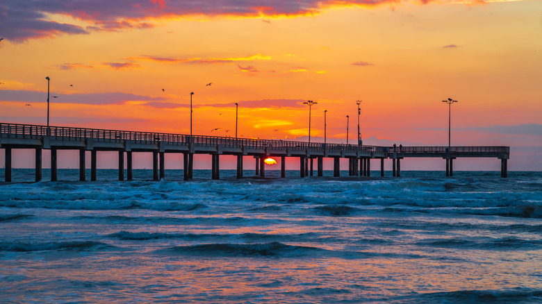 sun setting over pier in Port Aransas Texas