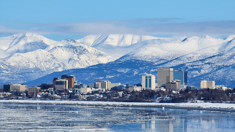 skyline of Anchorage, Alaska with snowy mountains in background