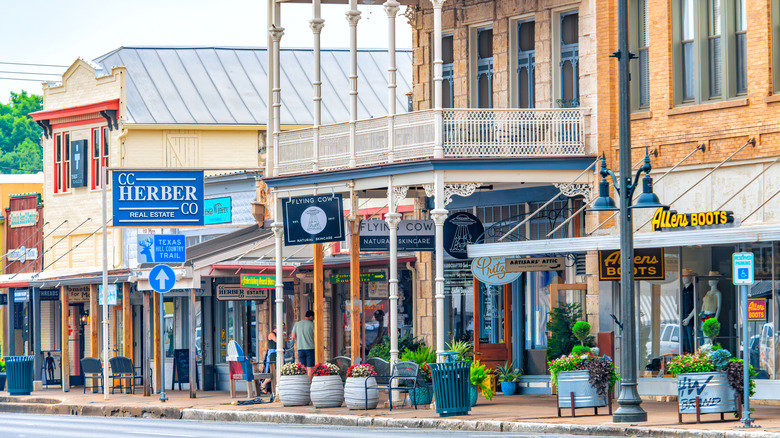 Shops lining the historic Main Street during the day in Fredericksburg, TX