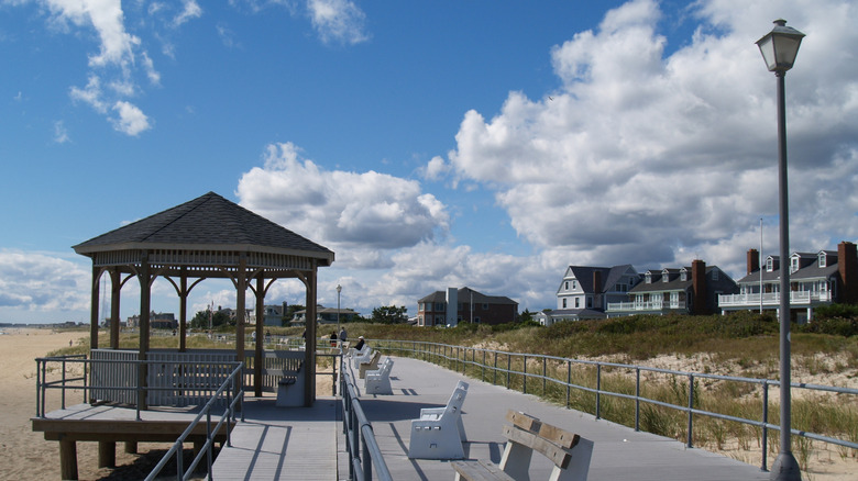 Boardwalk at Sea Girt Beach, with a gazebo and benches along the walkway and homes in the background