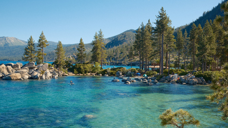 the turquoise water and rocky shoreline of Lake Tahoe, which straddles Nevada and California