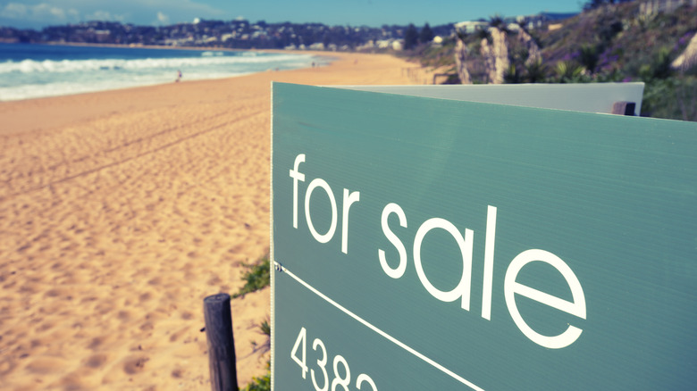 A for sale sign at the beach
