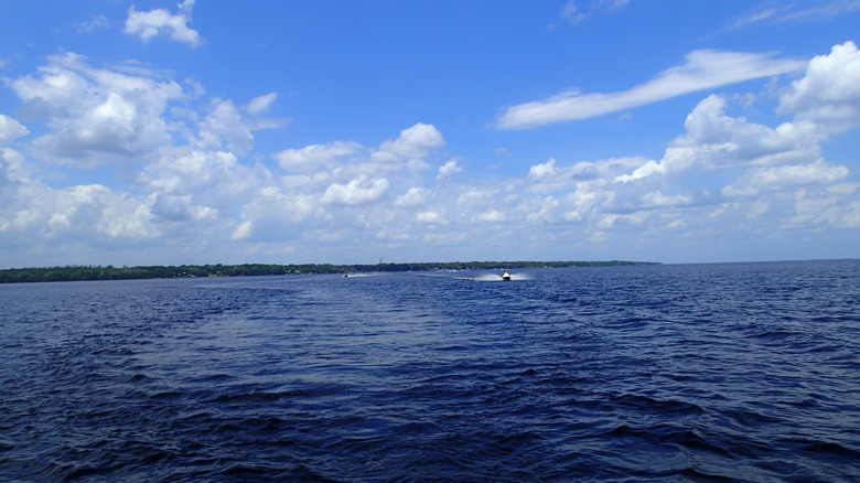 a lone boat cuts through the water at Crescent Lake