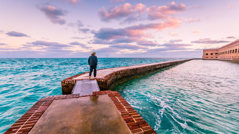 Person walking on walkway at sunset at Dry Tortugas National Park in the Florida Keys