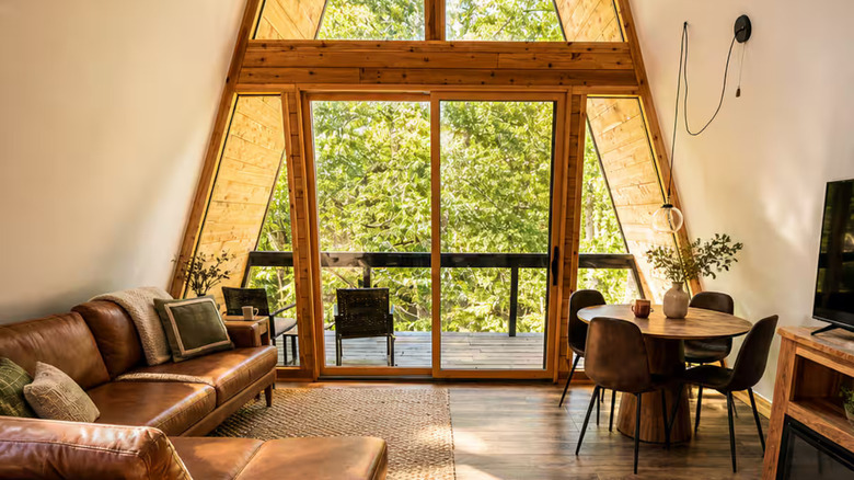 the tall windows of the A-frame cabin at Remotely Rogers provide great views and a cozy vibe