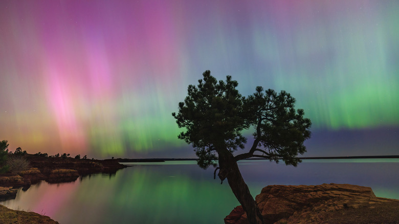 Vivid Aurora Borealis display reflected in the Glendo Reservoir in Glendo State Park, Wyoming