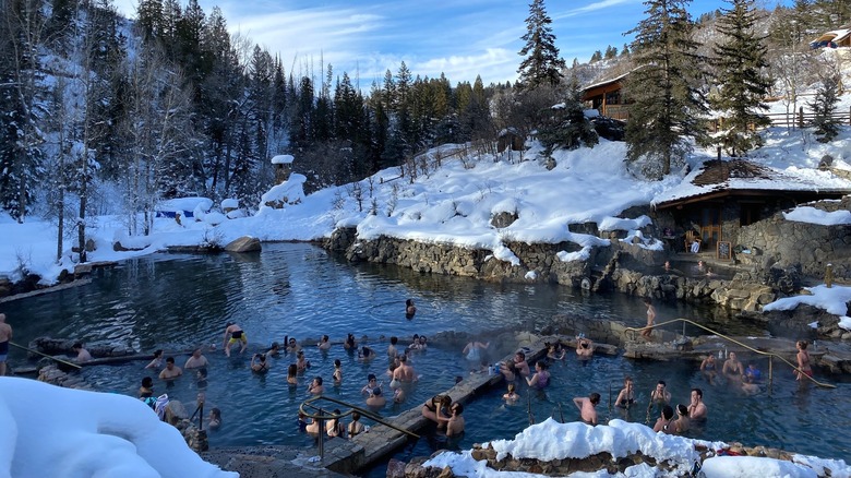 People bathing in Strawberry Park Hot Springs during winter.