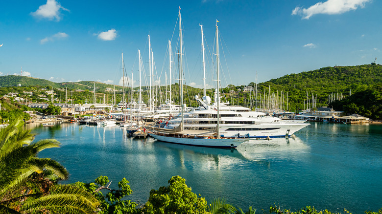 Wide angle shots of famous English Harbour in Antigua taken from a viewpoint, overlooking the port and marina with super yachts moored at the dock
