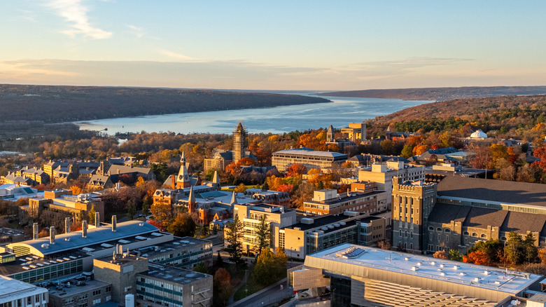 Aerial view of Ithaca, New York, amongst fall foliage backdropped by a finger shaped lake
