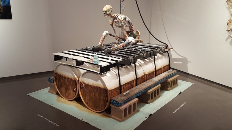 A contemporary art piece with a skeleton over barrels at 21c Museum Hotel Cincinnati.