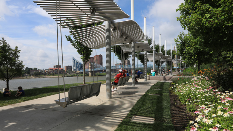 Visitors sit on swings overlooking the Ohio River at Smale Riverfront Park.